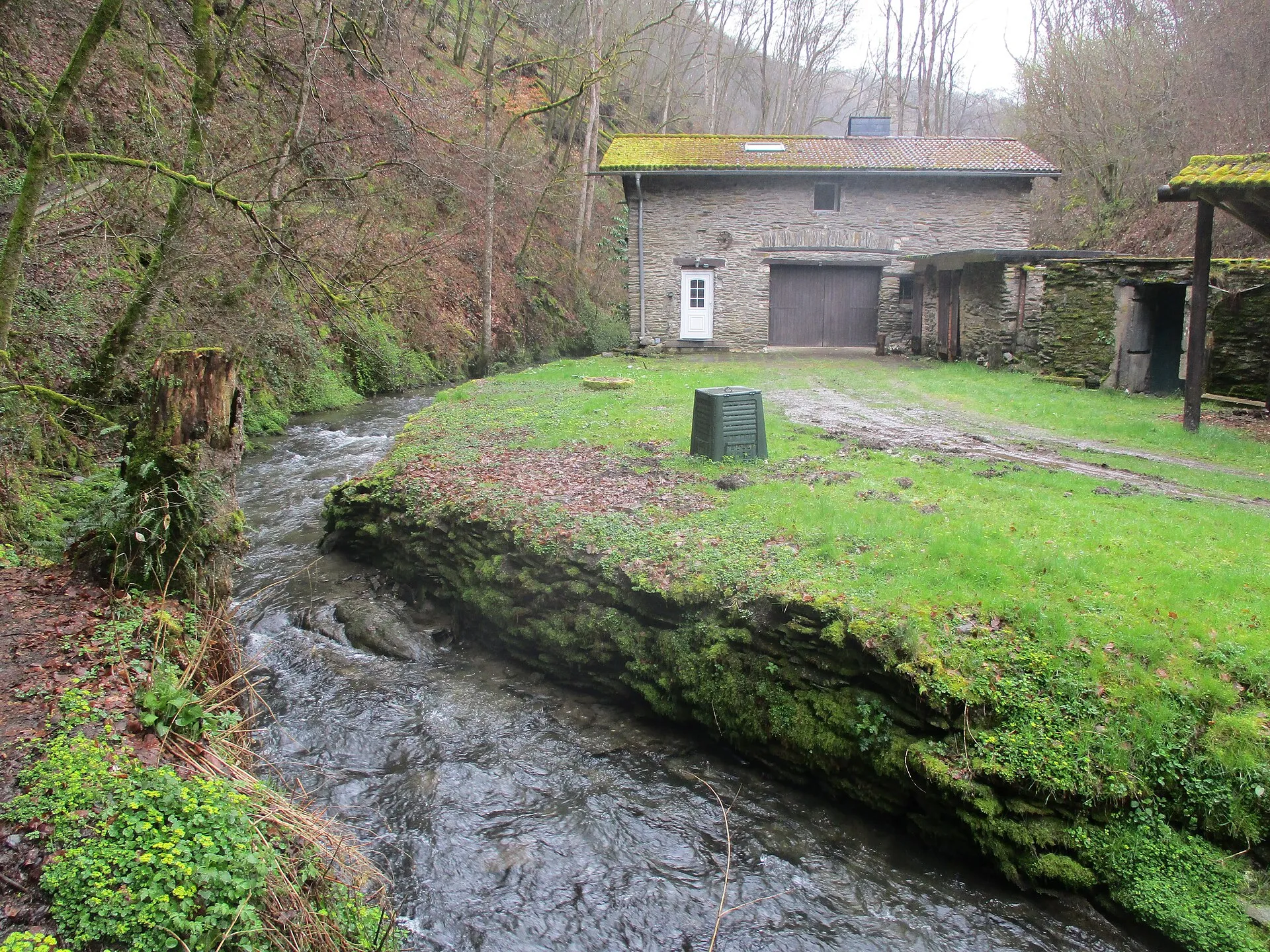 Die Endert fließt durch ein bewaldetes Tal, am Ufer steht ein altes Haus aus Bruchstein mit Ziegeldach